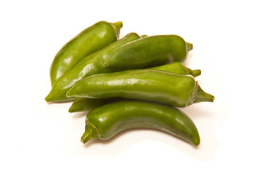 Green chilli peppers isolated on a white studio background.