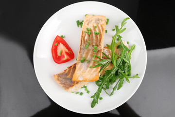 salmon fillet garnished with rocula