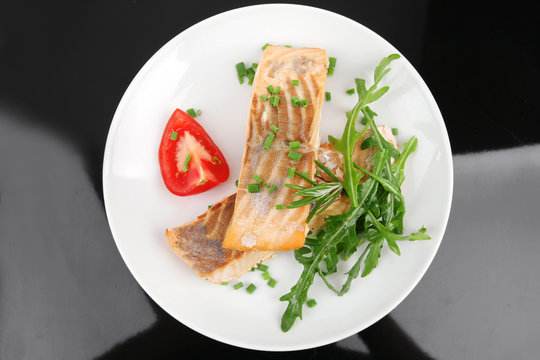 salmon fillet garnished with rocula