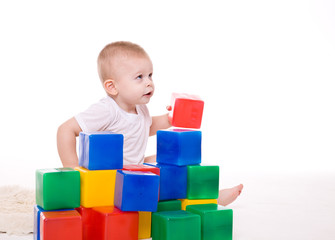 Baby boy plays with toy blocks