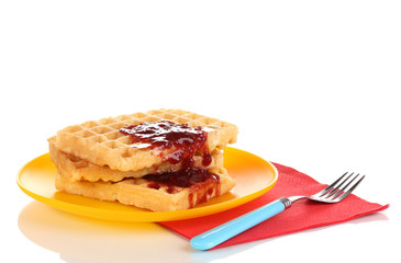 Tasty waffles with jam on plate isolated on white
