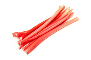 Rhubarb sticks or stalks on a white studio background.