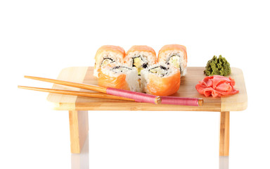 Tasty rolls served on wooden plate isolated on white