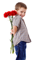 Smiling boy hiding a bouquet