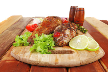 savory on wooden table: two fried fish