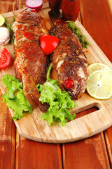 roasted sea fish and castors on wood