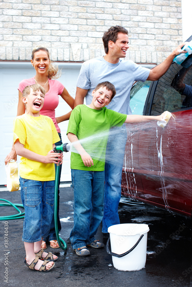 Wall mural Happy family washing the family car.