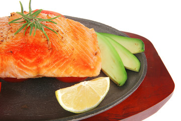 hot baked salmon piece served with vegetables