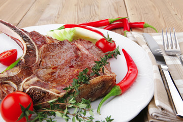 savory : grilled spare rib on white dish with pepper and tomato