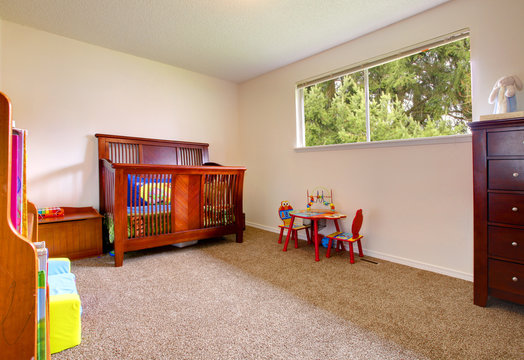Simple baby room with wood crip