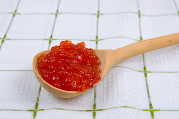 Wooden spoon with red caviar