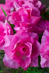 Pink artificial roses made ??of synthetic fiber.