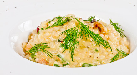 photo of delicious risotto with seafood and dill on it