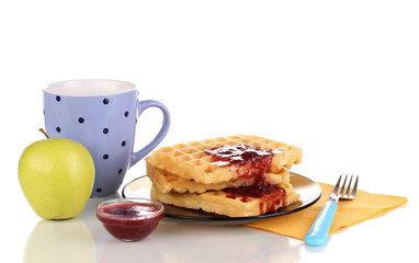 Tasty waffles with jam on plate isolated on white
