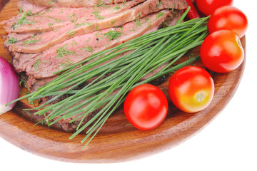 beef on wooden plate with peppers