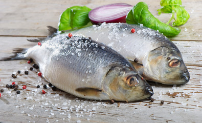 Two herrings on a wooden table