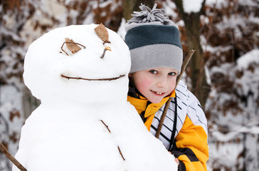 Boy and a snowman - a winter holiday