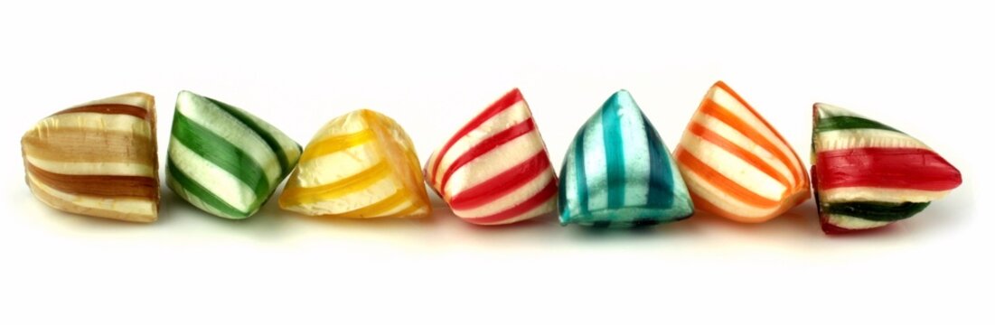 Colorful striped hard candies banner on a white background