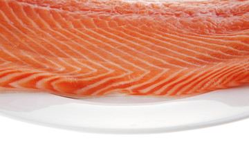 big salmon fillet on white plate