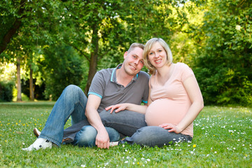 Pregnant couple in the park