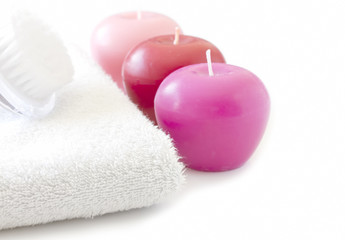 Fototapeta na wymiar White towel with pink candles and brush spa concept