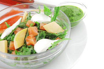 salad with salmon in transparent bowl
