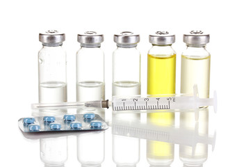 Syringe with medical ampoule and tablets isolated on white