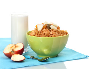 tasty cornflakes in bowl with dried fruits, glass of milk