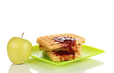 Tasty waffles with jam on plate isolated on white
