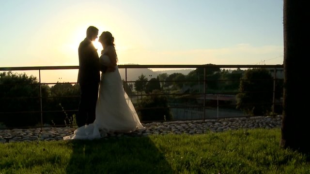 the wedding kiss at sunset