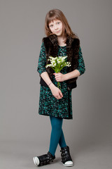 young happy girl.  little girl on a gray background.  Happy chil