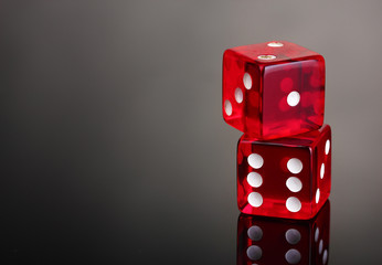 Red dices on grey background