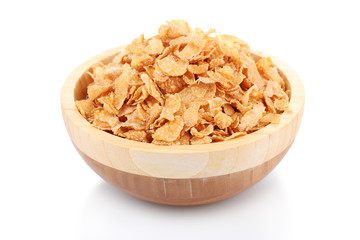 tasty cornflakes in wooden bowl isolated on white