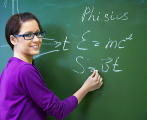 girl student wearing glasses at the blackboard