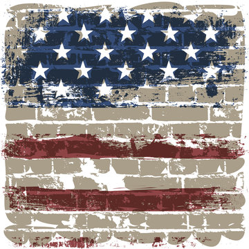The American flag against a brick wall.
