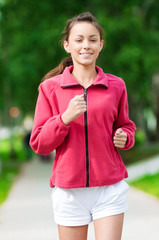 Teenage girl running in green park