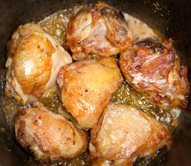 Chicken meat is fried in a copper with spices