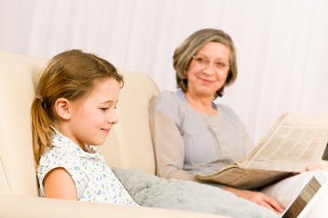 Young girl using laptop grandmother relax