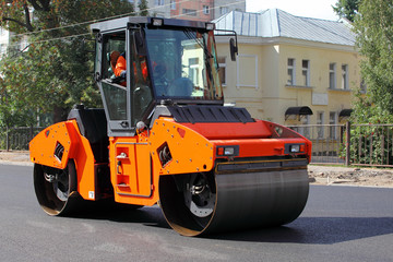 Steamroller asphalting a street