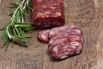 salami on wooden background close up