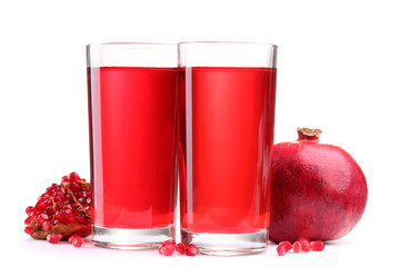 ripe pomergranate and glasses of juice isolated on white.