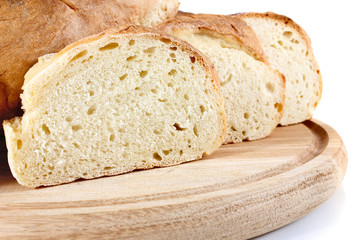 homemade bread on wooden breadboard isolated white background
