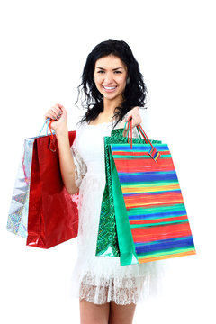 Happy shopping woman holding bags isolated on white