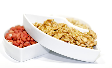White plats with walnuts, peanut and pine nut