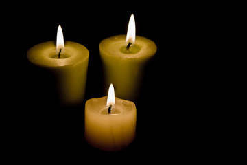 Three Candles on black background