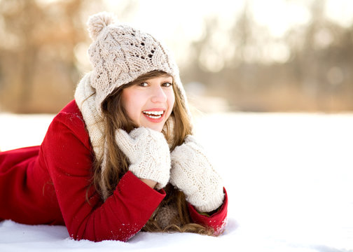 Smiling Woman Lying in the Snow