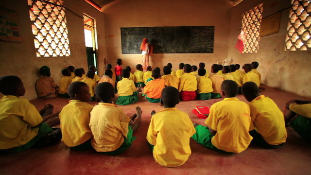 Teacher In A Classroom Filled With Students In Kenya, Africa