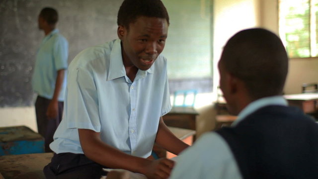 Students taking a test in a class in an African school.