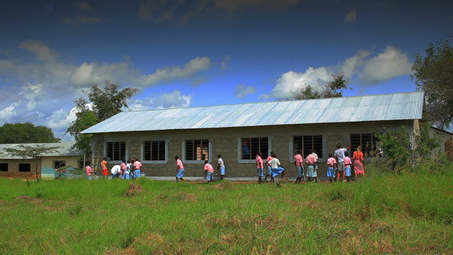 Painting the exterior of a school in Kenya.