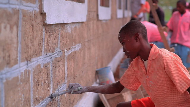 Painting the outside of a school in a village in Kenya.